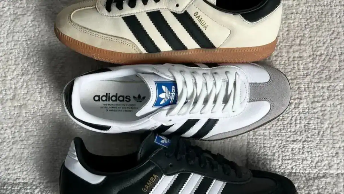 Person wearing Adidas Samba sneakers with blue jeans, showing the slim toe box shape