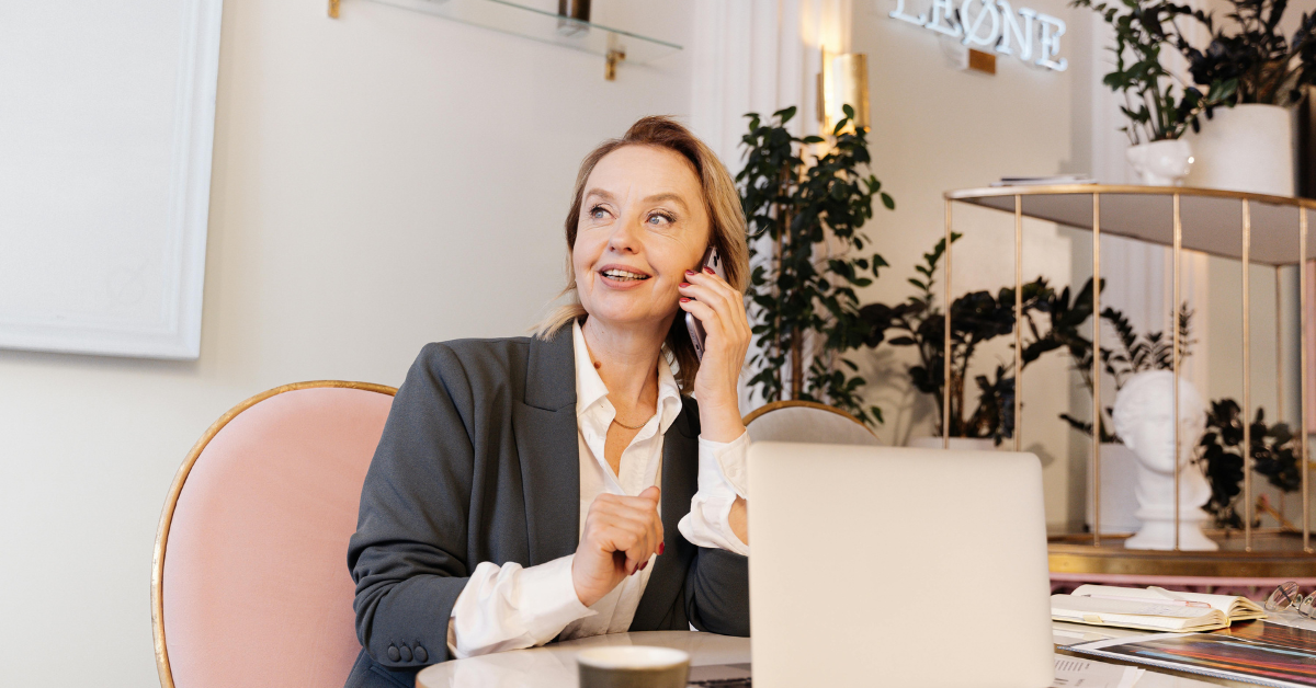 Woman wearing a business casual outfit with blouse and tailored trousers in a professional office style