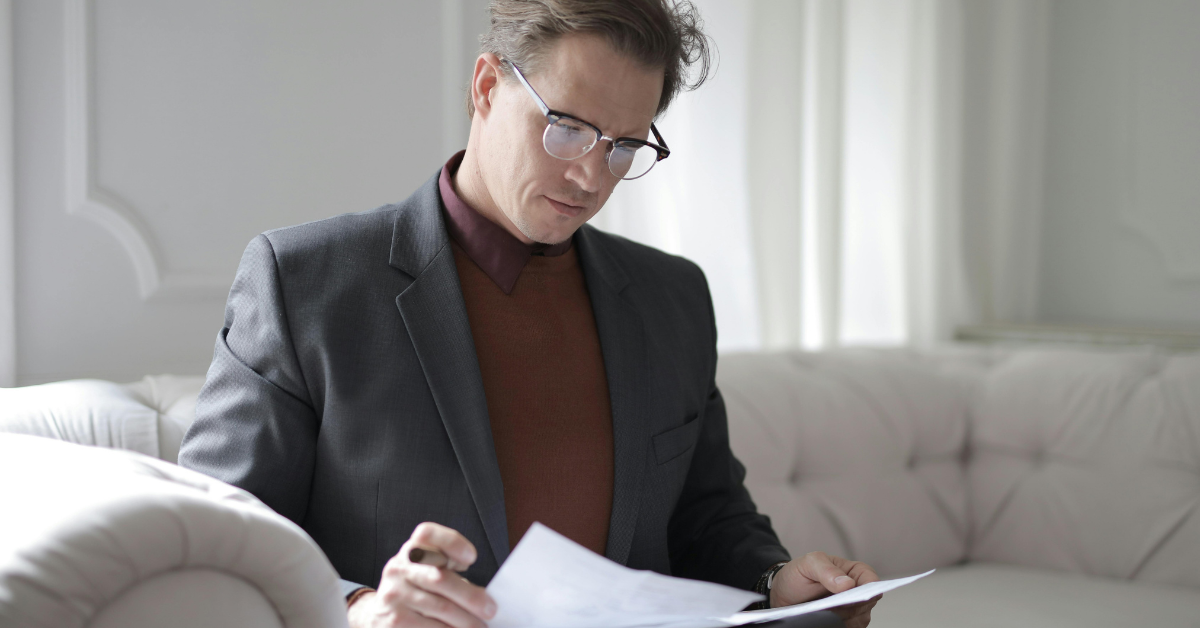 man wearing blazer and sweater classic preppy style outfit