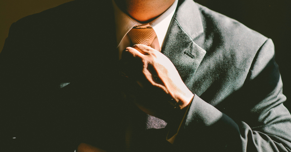 man tying different tie knots for formal and casual occasions
