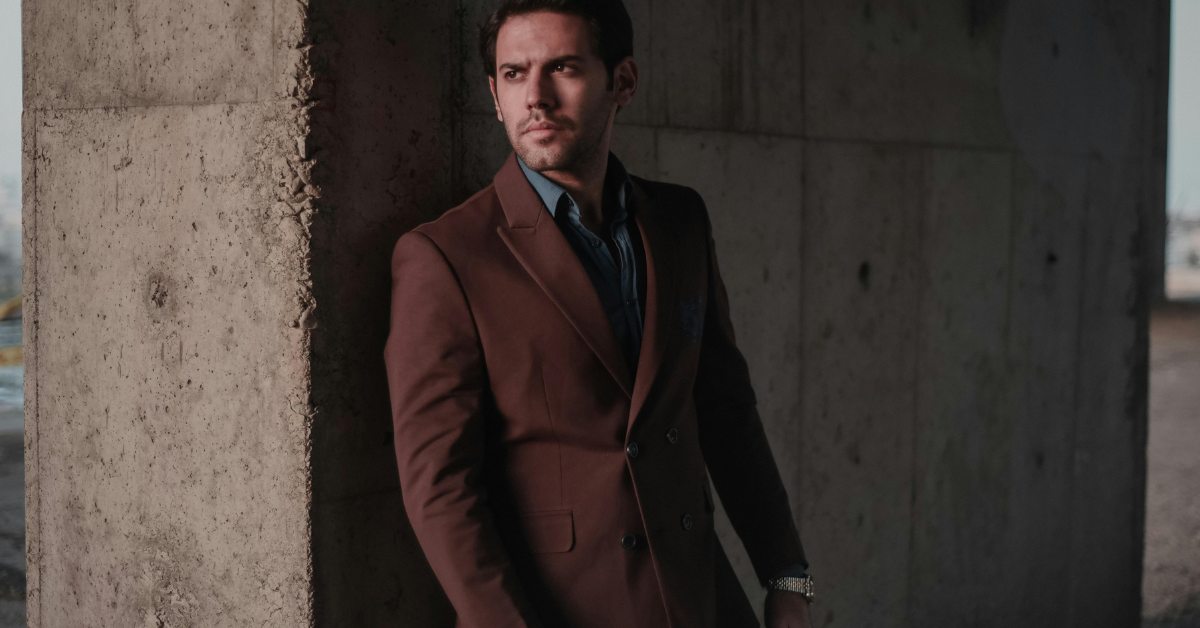 Modern man wearing smart casual outfit with blazer chinos and sneakers clean stylish everyday look