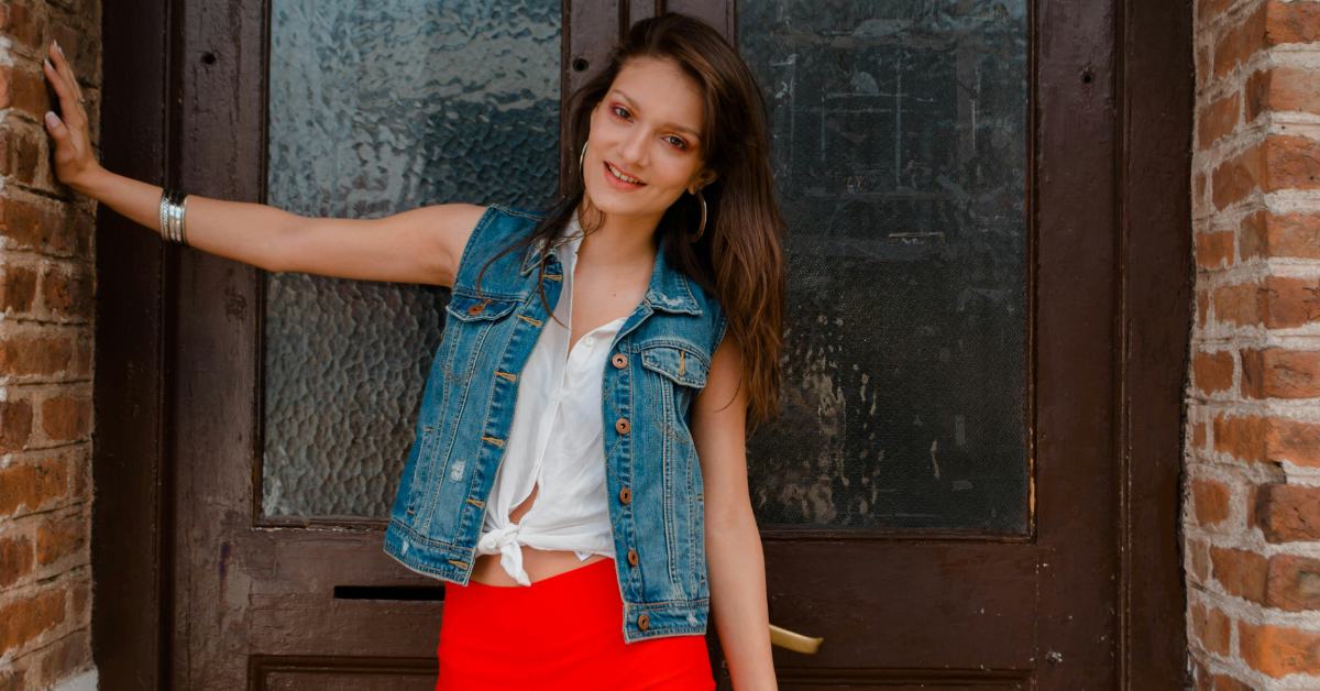woman wearing a denim vest styled with casual modern outfit