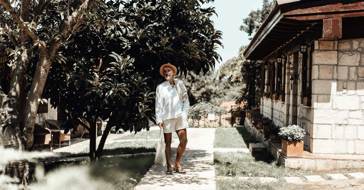 Man wearing a stylish summer outfit with linen shirt and chinos outdoors