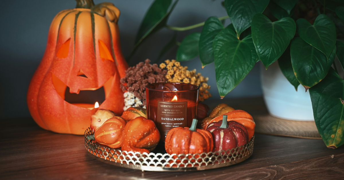 Aesthetic Halloween decor with pumpkins candles and warm autumn lighting