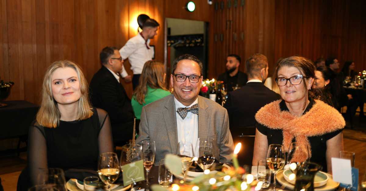 Man wearing a tailored suit at a cocktail event demonstrating modern men's cocktail attire style